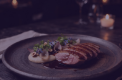 A plated dish on a dark table
